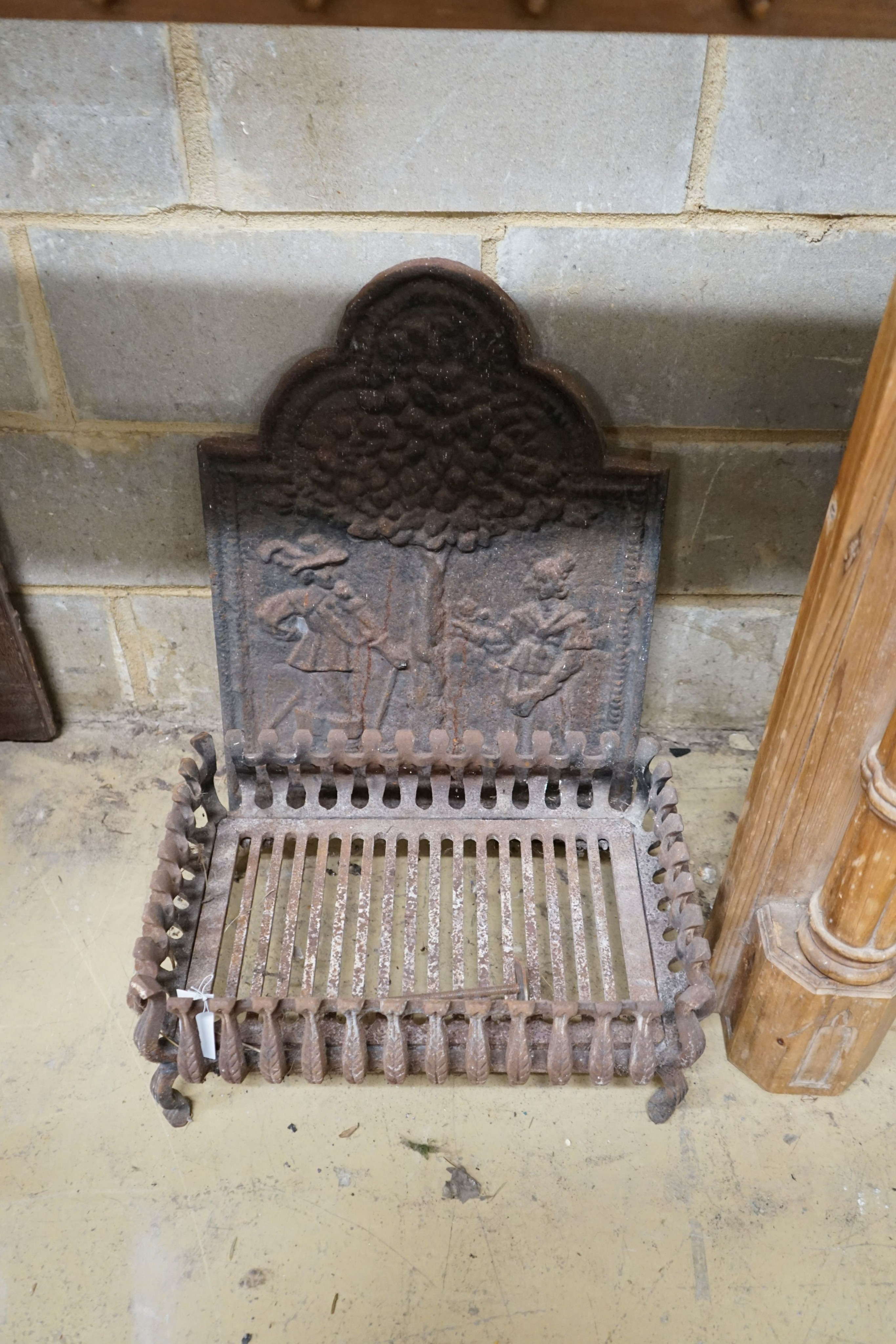 A George III style limewood chimneypiece, in the Strawberry Hill Gothic style, width 150cm, height 111cm together with a cast iron fireback and fire basket (3)